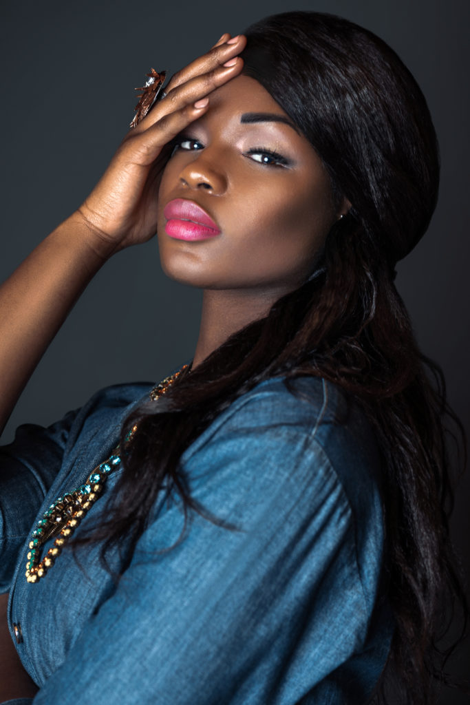 Black girl wearing a blue denim romper for Spring 2021 Fashion Trends 