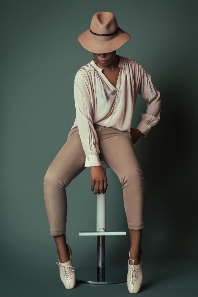 Black girl wearing a blouse with beige pants for Spring 2021 Fashion Trends